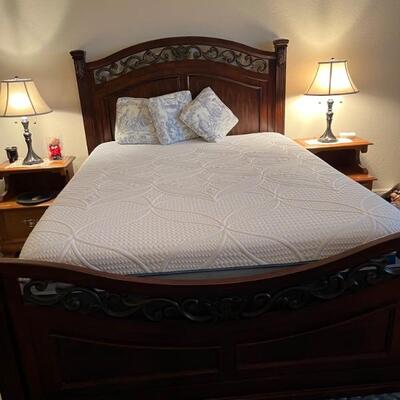 Beautiful dark wood and wrought iron queen bed and rails