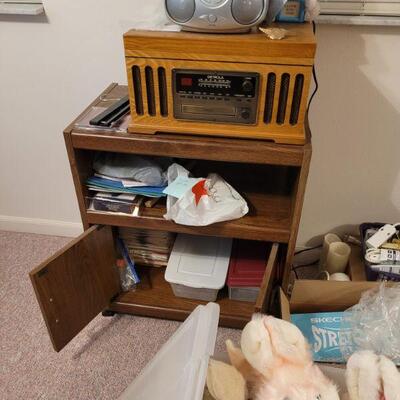 small cabinet with one door and a radio combo player