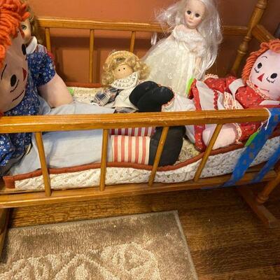 Assorted Dolls and childs play crib  