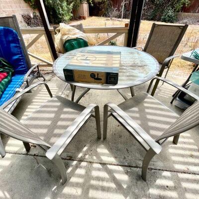 Patio set. Glass top table & 4 high back chairs 