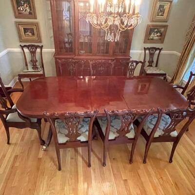 Chippendale dining room table with 10 chairs. Includes one 18 1/2 inch leaf. Measures approximately 42 x 92. Like new! One arm chair has...