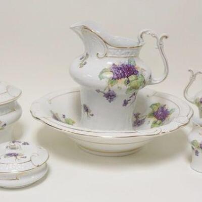 1006	7 PIECE STONEWARE CHAMBER SET W/ HAND PAINTED VIOLETS. CHAMBER POT LID HAS CHIP INSIDE. PITCHER APP. 12 IN H 
