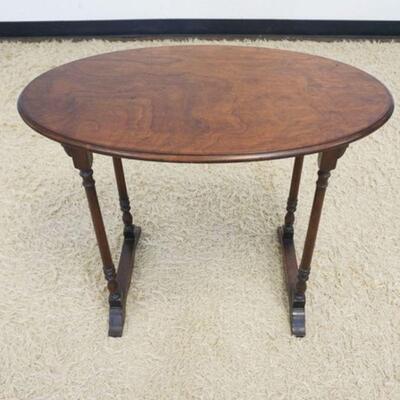 1056	OVAL WALNUT OCCASSIONAL STAND, APPROXIMATELY 31 IN X 18 IN X 25 IN HIGH
