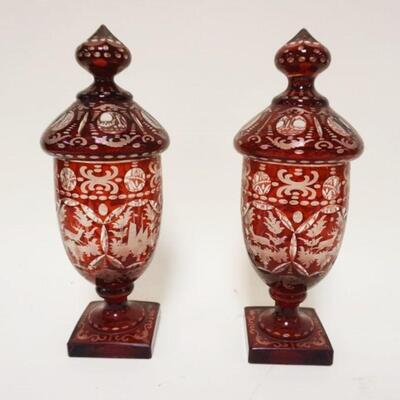 1127	PAIR OF OUTSTANDING ANTIQUE BOHEMIAN COVERED JARS, RUBY CUT TO CLEAR W/INTRICATE PANELED SCENES, APPROXIMATELY 13 IN HIGH
