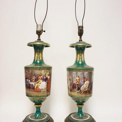 1161	PAIR OF PORCELAIN HAND PAINTED URN LAMPS DEPICTING BANQUET SCENES W/GILT TRIM ACCENTS, APPROXIMATELY 21 IN HIGH BEFORE HARP, APPEARS...