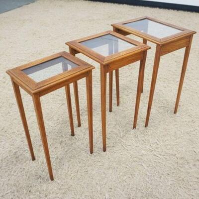 1082	NEST OF 3 WALNUT TABLES W/INSET GLASS TOPS, APPROXIMATELY 15 IN X 12 IN X 23 IN HIGH
