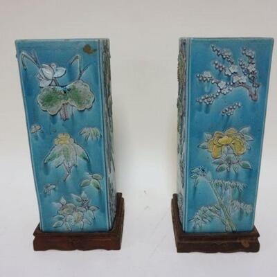 1128	PAIR OF SQUARE POTTERY CHINESE VASES ON WOOD BASES, CHARACTER MARKS ON BASE, RELIEF FLORAL DECORATIONS ALL AROUND, APPROXIMATELY 12...