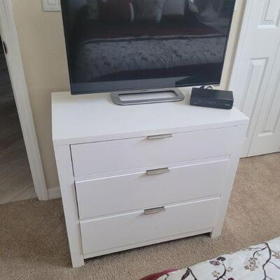 small chest of drawers and a tv