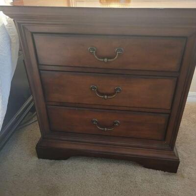 One of a pair of nightstands that match the bed, chest and dresser