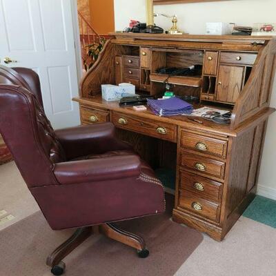 Roll top desk and padded office chair