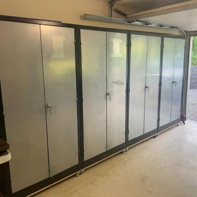 Six matching metal storage cabinets on wheels, most have keys