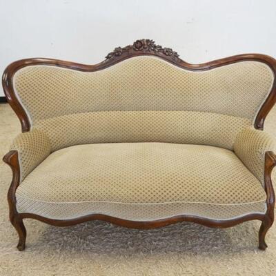 1029	WALNUT VICTORIAN HUMP BACK SETTEE W/FLORAL CARVED CREST, APPROXIMATELY 64 IN C 44 IN HIGH
