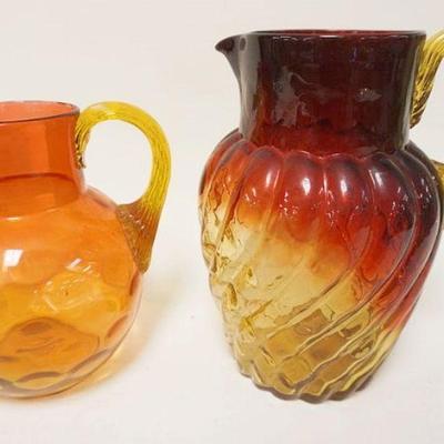 1290	2 VICTORIAN BLOWN GLASS AMBERINA PITCHERS W/APPLIED HANDLES, LARGEST IS APPROXIMATELY 9 1/2 IN HIGH
