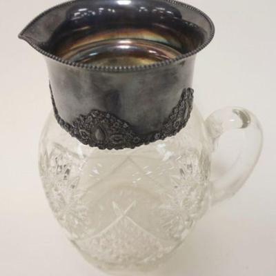 1216	VICTORIAN PRESSED GLASS WATER PITCHER WITH SILVER PLATE TOP COLLAR, APPROXIMATELY 10 IN HIGH
