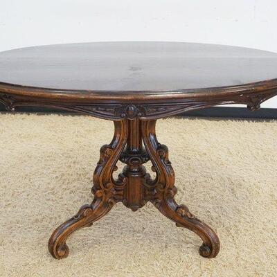 1028	VICTORIAN OVAL PARLOR TABLE W/WITH AN ORNATELY CARVED BASE, APPROXIMATELY 48 IN X 34 IN X 30 IN HIGH
