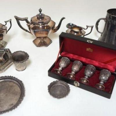 1089	GROUP OF SILVER PLATE ITEMS INCLUDING 3 PIECE TEA SET, TRAYS, TROPHY CUP, HOT PLATE AND 4 WINES IN BOX.
