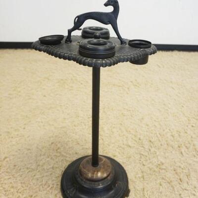 1011	CAST IRON SMOKING STAND, FIGURE OF A GREYHOUND DOG AT TOP, APPROXIMATELY 16 IN X 13 IN X 28 IN HIGH
