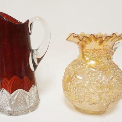 1243	2 PITCHERS INCLUDING CARNIVAL FLORAL & GRAPE & BUTTON ARCHES RUBY STAINED, LARGEST IS APPROXIMATELY 11 IN HIGH
