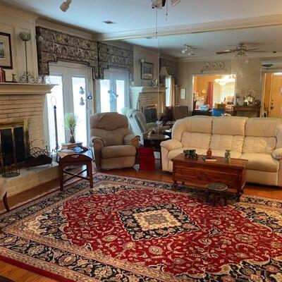 Large oriental rug, cedar chest, cream faux leather sofa, recliner