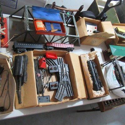 VINTAGE LIONEL TRAIN SET WITH SOLID METAL ENGINE, CRANE CAR, OTHER BOX CARS, CABOOSE WITH CONTROLLER AND TRACKS. OTHER ACCESSORIES ALSO...