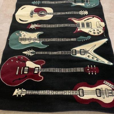 This is a rug with a bunch of guitars on it in the print