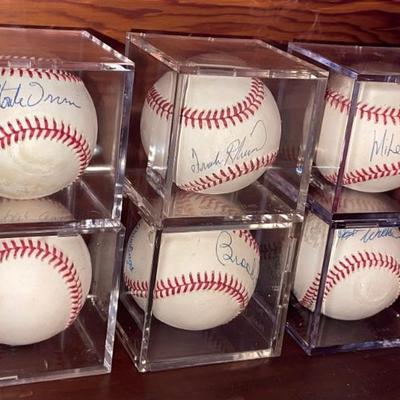 Seven autographed baseballs by MLB Hall of Fame legends Hank Aaron, Brooks Robinson, Monte Irvin, Jim Palmer, Hoyt Wilhelm, Frank...