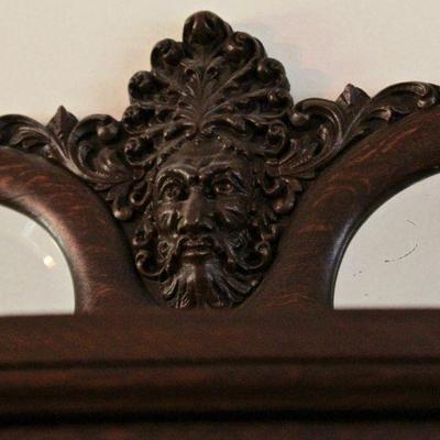 Detail - close up of carved face on china cabinet.