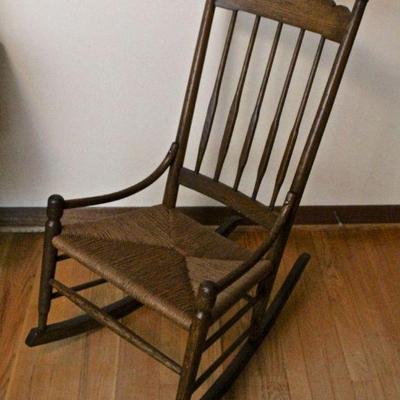Antique oak rocking chair with rush seat.