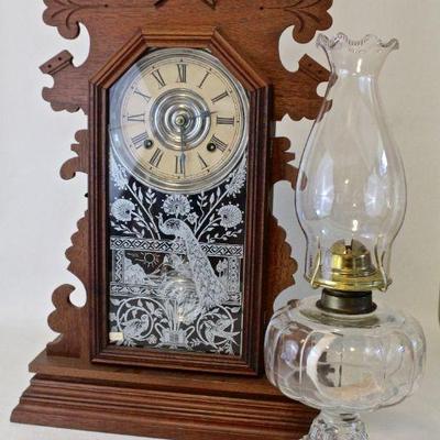 Antique Ansonia kitchen clock and oil lamp.
