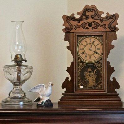 Antique New Haven kitchen clock, oil glass lamp, porcelain bird figurine.