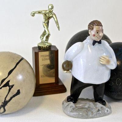 Glass bowler sculpture, vintage duck pin bowling balls, and bowling trophy.