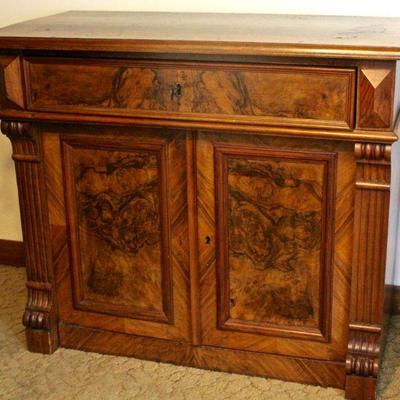 Elegant wash stand decorated with burl wood and column motifs - single drawer with cabinet below.