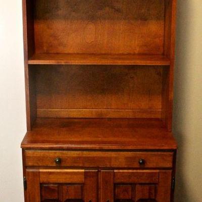 Wooden cupboard - display shelves, drawer, and lower cabinet storage.