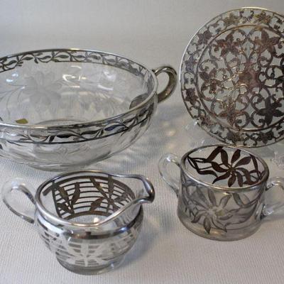 Glass bowl, trivet, and sugar bowls with silver overlay.