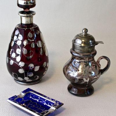 Colored glass with silver overlay - syrup pitcher, ash tray, and decanter. 