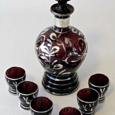 Purple glass decanter and 6 cordial glasses with silver overlay.