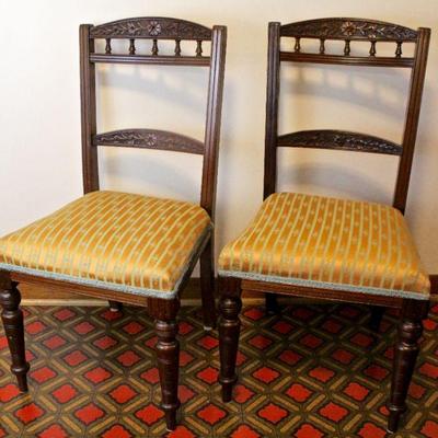 Pair of mahogany side chairs with dainty turned spindles and carving on backs.