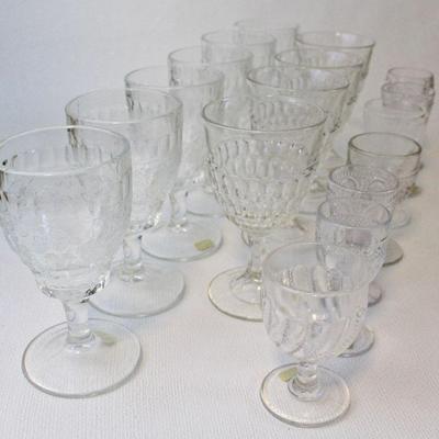 Early American Pattern Glass collection that includes matched sets of goblets and individual Victorian-Edwardian era 2 ounce wine glasses.
