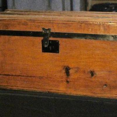 Small wooden trunk with slat top.
