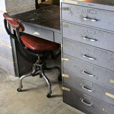 Steel desk with attached chest of drawers.