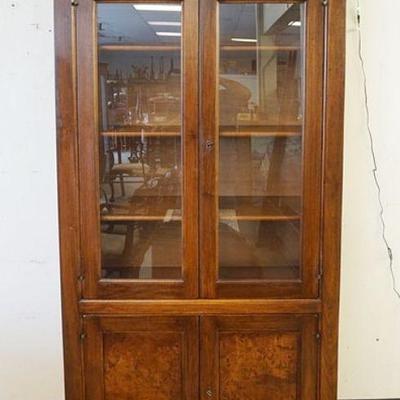 1015	4 DOOR DISPLAY CABINET, 2 GLASS DOORS OVER 2 BURLED PANELED IN WALNUT FINISH, APPROXIMATELY 42 IN X 20 IN X 79 IN HIGH

