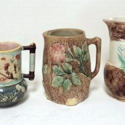 1162	5 MAJOLICA PITCHERS	LOT OF 5 MAJOLICA PITCHERS, 2 WITH CHIPS NEAR SPOUTS, TALLEST IS APPROXIMATELY 9 1/2 IN HIGH
