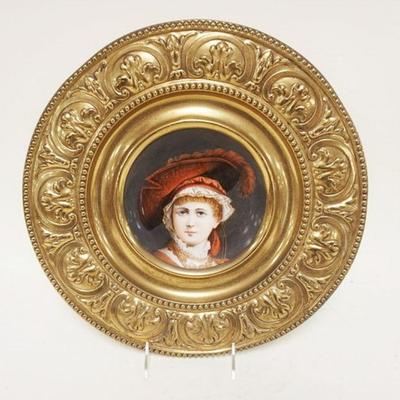 1148	ANTIQUE HAND PAINTED PLATE	ANTIQUE HAND PAINTED PLATE OF VICTORIAN WOMAN MOUNTED IN ORNATE BRASS FRAME, APPROXIMATELY 14 IN
