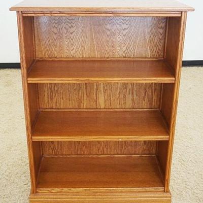 1021	SOLID OAK BOOKCASE W/PANELED SIDES, APPROXIMATELY 39 IN X 17 IN X 52 IN HIGH
