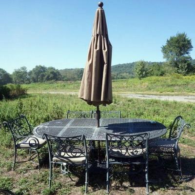 1292	CAST METAL PAITO SET	CAST METAL PATIO SET WITH TABLE AND 6 ARM CHAIRS AND UMBRELLA, TABLE APPROXIMATELY 84 IN X 42 IN X 29 IN HIGH
