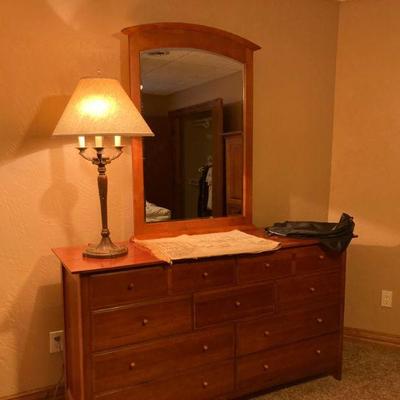 Dresser with mirror and a lamp