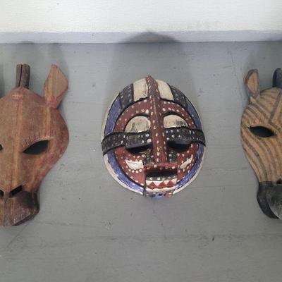 This is a lot of three African masks, it includes a modern Zebra head and Giraffe form, West African Bambara painted human figural, The...