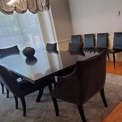 Long black dining table with pedestal base