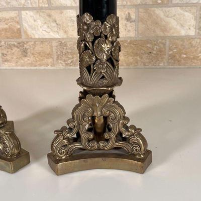 PAIR CANDLESTICK HOLDERS | Black enamel porcelain column on a shaped brass base with floral motif; h. 15-1/2 in.
