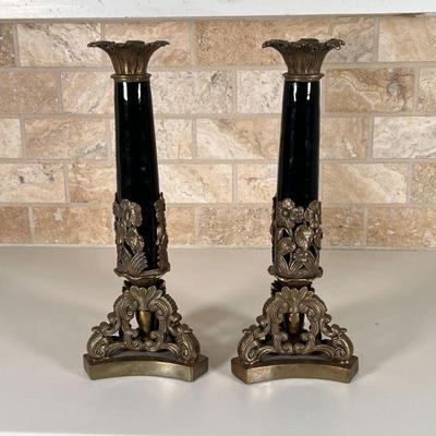 PAIR CANDLESTICK HOLDERS | Black enamel porcelain column on a shaped brass base with floral motif; h. 15-1/2 in.